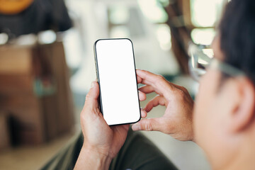 Wall Mural - cell phone blank white screen mockup.hand holding texting using mobile on desk at office.background empty space for advertise.work people contact marketing business,technology