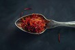 © At My Hat - A spoonful of red spice is shown on a black background