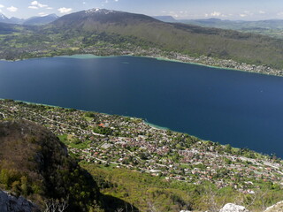 view of Annecy lake from mont Veyrier and mont Baron hike in Haute savoie. Aerial view of Veyrier du lac town and Semnoz summit