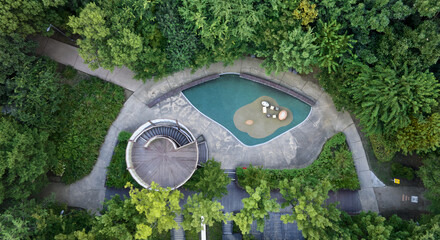 Wall Mural - Seongsu-dong, Seongdong-gu, Seoul, South Korea - September 18, 2022: Aerial and top angle view of round deck observatory and trail amid forest at Seoul Forest in summer
