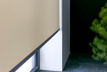 Fototapete - Roller blinds on full height window. Automated smart curtains indoors. A beige electric roller shade covers a large window, providing a minimalist aesthetic while filtering natural light.  