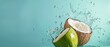 © faysal - Isolated against a copy space backdrop of pastel summer blue, coconut water splattering out of a fresh green coconut, Generative AI.