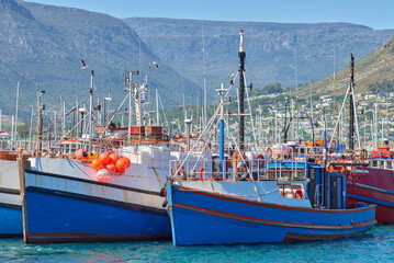 Wall Mural - Harbor, ship and ocean for fishing with boats for shipping, coastline industry and summer scenery. Port, dock and water, waves and sea for sailing, nature and seascape bay with holiday destination