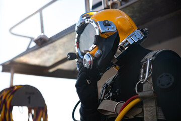 Wall Mural - Commercial diver entering water in protective helmet