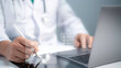© Toowongsa - Medical performance checklist, Medical worker using laptop doing online checklist survey, filling out digital form checklist, take an assessment, questionnaire, evaluation, online survey, online exam.