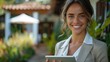 © umar - Smiling Woman Holding Tablet in Serene Outdoor Garden During Bright Daylight