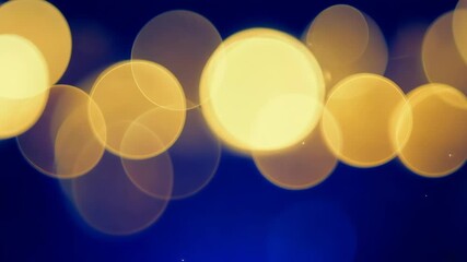 Blurry yellow light bokeh on dark blue
