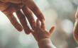 © Curioso.Photography - Adult and baby hands touching gently with soft background light.