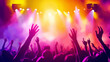 © Curioso.Photography - Concert crowd with hands raised enjoying a vibrant light show on stage.