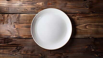 Empty white plate on a textured wooden background, top view. Great for food presentations or creative text placement.