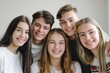 © Ольга Лукьяненко - Group of Confident Young People Smiling and Looking at Camera Indoors bright class