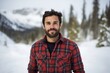 © Markus Schröder - Portrait of a glad man in his 30s wearing a comfy flannel shirt isolated on pristine snowy mountain