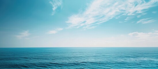 Poster - Scenic view of the sea and sky meeting at the horizon with a clear blue color palette in the copy space image