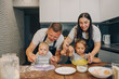 © SeniaDm - Gathering the Family for Cooking Together A Joyful and Fun Experience in the Kitchen. Happy family enjoys moments of cooking at home.