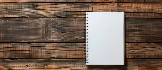 Aufkleber - Top view of a notebook paper on a wooden surface ideal for business and education concepts with ample copy space image