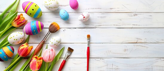 Aufkleber - Easter themed arrangement with vivid eggs paint tools and tulips on a white wood surface shot from above showcasing a copy space image