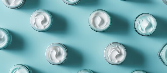 Leinwandbilder - Top view of face cream samples on a light blue background with room for text in the image in question