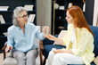 © Maria Vitkovska - Psychotherapist giving glass of water to young woman during therapy session