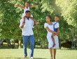 © peopleimages.com - Black family, walking and smile in nature with love for bonding together, fun activity and care outdoor. People, parents or kids in park for summer holiday, wellness or support in natural environment