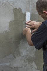 Wall Mural - A man is painting a wall with a white tape