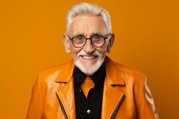 Canvas Print - Portrait of a grinning elderly 100 years old man sporting a stylish leather blazer over pastel orange background