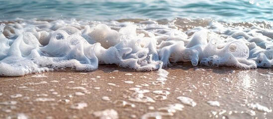 Aufkleber - Sandy beach in summertime with gentle waves and white foam ideal as copy space image for travel themes