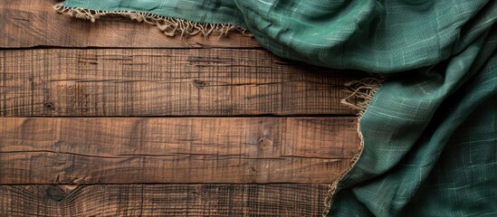 Poster - Top view of an empty wooden table with a green tablecloth showcasing a rustic backdrop and space for inserting images or text. Creative banner. Copyspace image