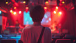 © Neat Design Studio - A shot from the back of a young person at a small concert hall watching a band on stage getting ready to perform with space for text