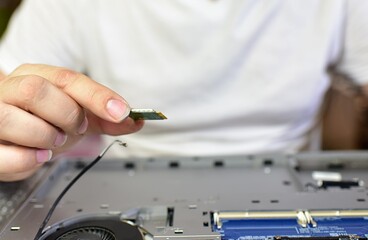 a man is repairing a laptop