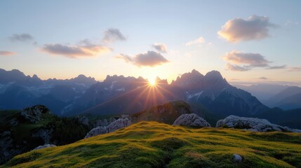 Poster - The sun is setting behind the mountains, casting a warm glow over the grassy hill. The sky is filled with clouds, creating a serene and peaceful atmosphere