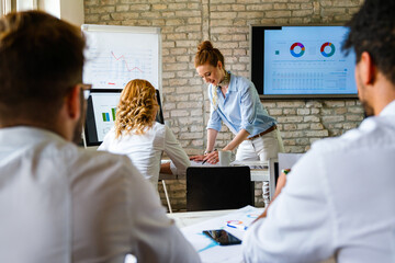 Wall Mural - Successful business woman ceo executive manager showing to colleagues team income revenue data