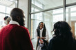 © Jacob Lund - Successful black woman engaging with colleagues in a corporate meeting
