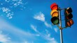 © Cherkasova Alie - Image of traffic lights showing green, yellow, and red, with a bright blue sky and clouds in the background. Concept of transportation and traffic control.