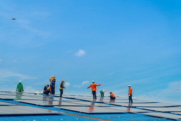Wall Mural - worker technicians are working to construct solar panels system on roof. installing solar photovolta