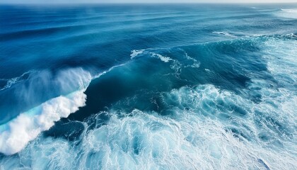 Wall Mural - beautiful photo of blue water flowing in waves with white foam in a ocean taken from up top above perspective wallpaper background 16 9