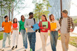 © Jose Calsina - Big group of international classmates walking and talking together on the university campus. Happy multiethnic students laughing while going to academy class. Young mates chatting back to high school