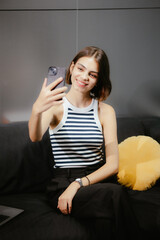 Poster - Woman Taking a Selfie on Couch