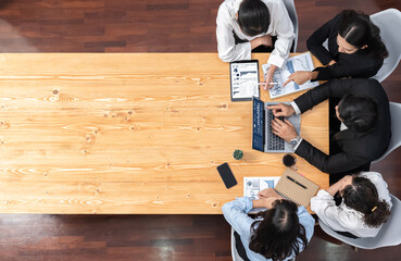 Wall Mural - Panorama top view diverse group of business analyst team analyzing financial data report paper on meeting table. Chart and graph dashboard by business intelligence analysis. Meticulous