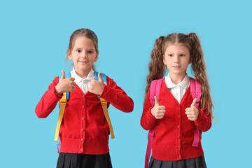 Poster - Little schoolgirls with backpacks on blue background