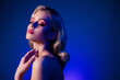 © Beauty Hero - Photo of attractive girl with closed eyes touch body feel tenderness in blue color neon background