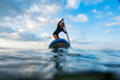© UP - Young woman on the sea with a paddle surf board