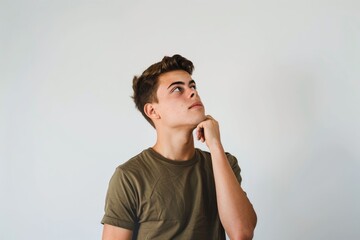 Wall Mural - Handsome man making thoughtful choice  looking up on white background