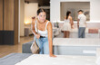 © JackF - Pleased young girl choosing convenient mattress in large furniture shop