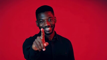 Wall Mural - Portrait of Thoughtful Man in Black Shirt Against Red Background - Emotional Contemplation