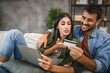 © Miljan Živković - Adult couple buy online on digital tablet with credit card at home
