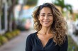 © darshika - Confident middle aged Hispanic woman smiling on street