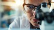 © svastix - A blurred close-up of a laboratory professional working diligently in a modern lab environment, symbolizing dedication, scientific exploration, and technological advancement.
