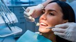 © BISO - A woman's face, with the dentist's hands visible, examining her teeth at a dental clinic.