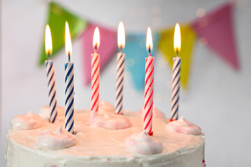 Wall Mural - Tasty Birthday cake with burning candles against blurred background, closeup