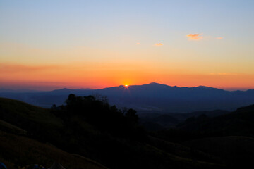 Mountain sunrise landscape orange sky in the morning Amazing nature scenery. Tourism and travel concept